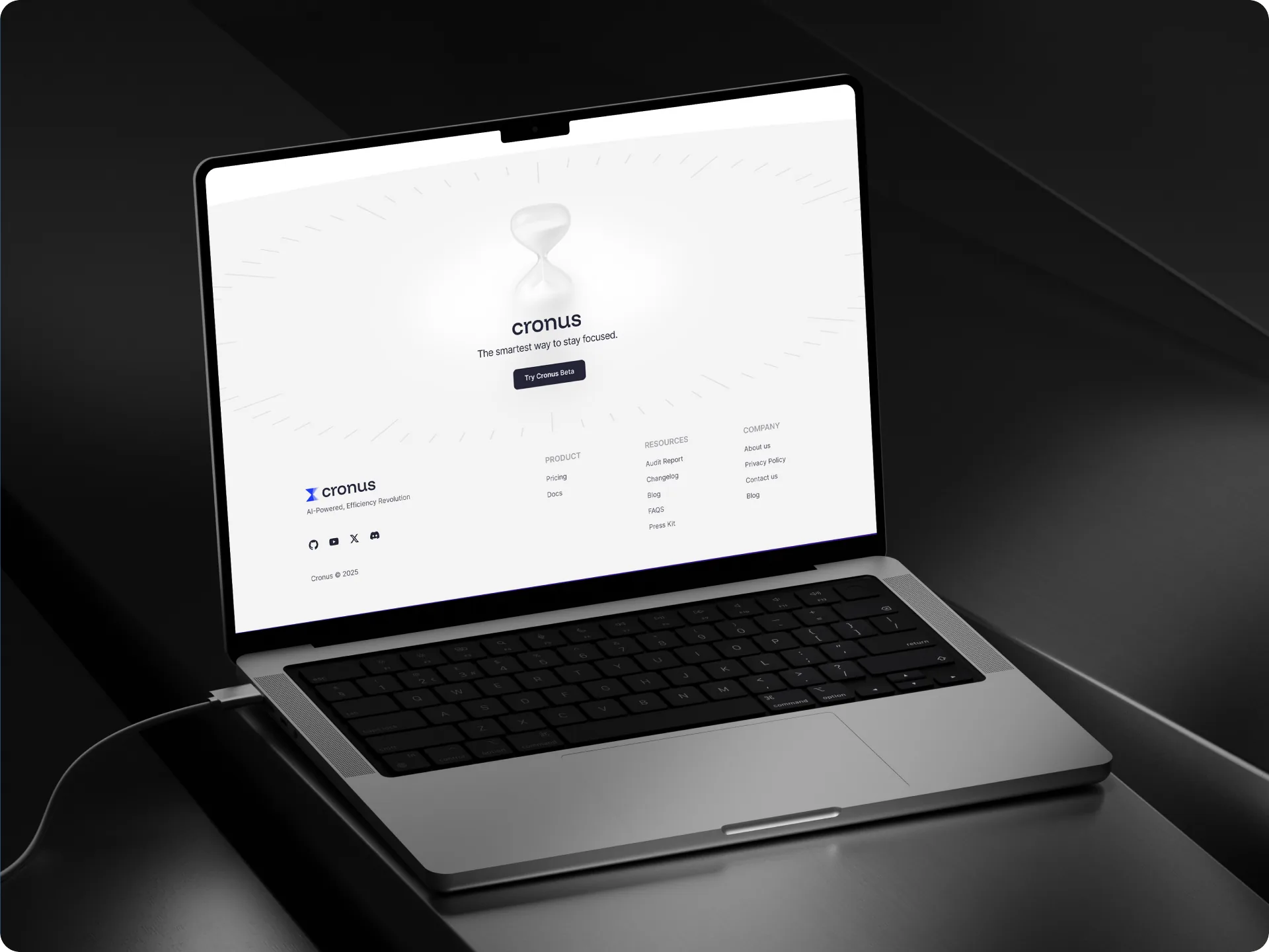Closing shot — the Cronus site on a MacBook in a dark studio
